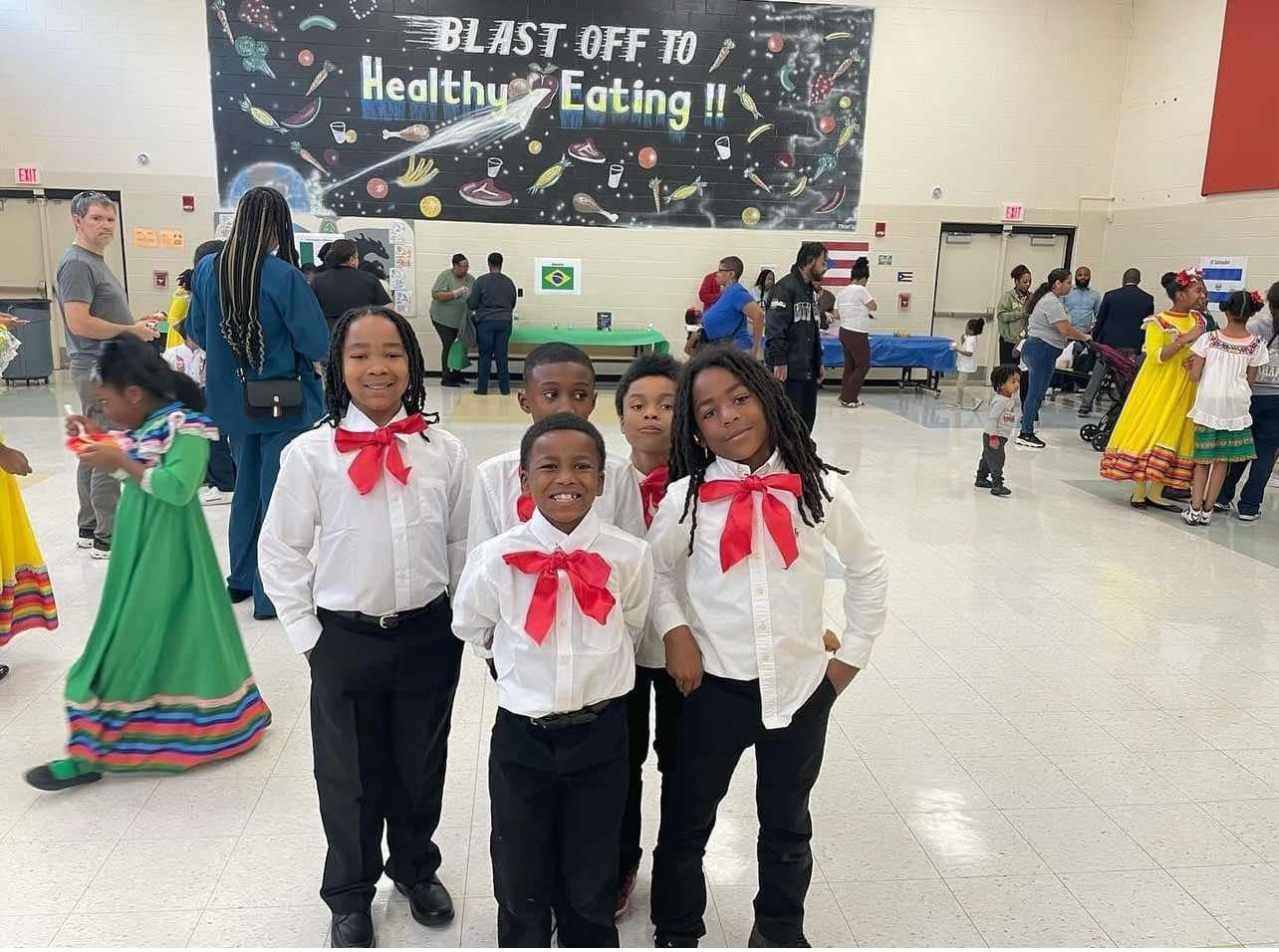 male students in attire for hispanic heritage performance