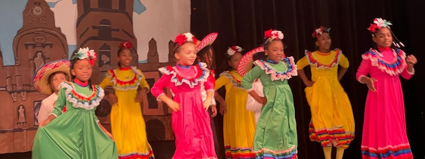 students dancing in traditional hispanic attire